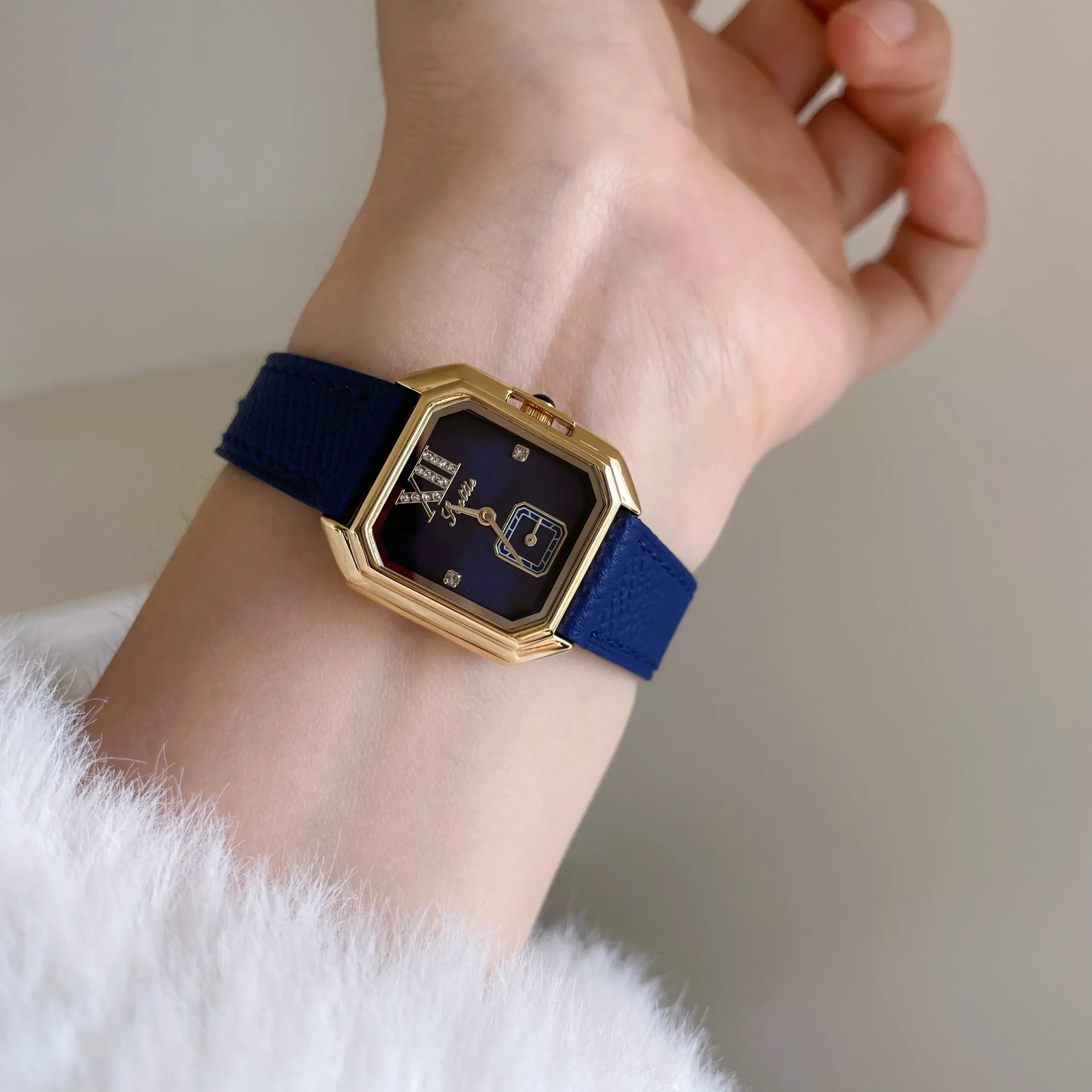Vintage ladies watch with blue leather strap and gold rectangular case
