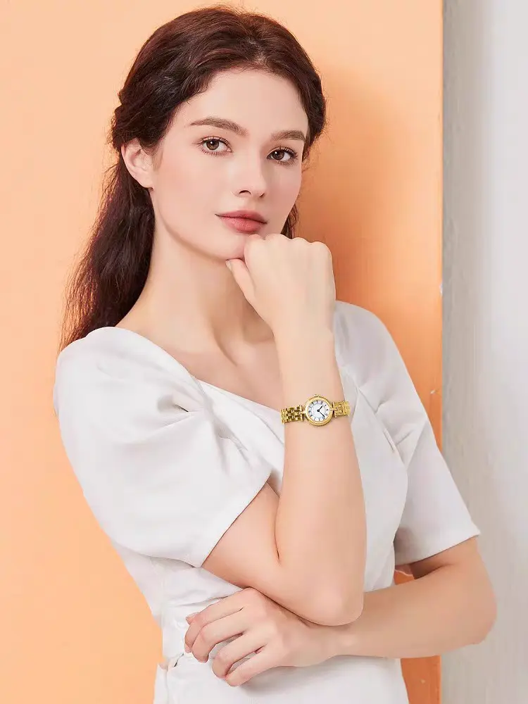 Elegant woman wearing a vintage gold wristwatch from WatchTrio