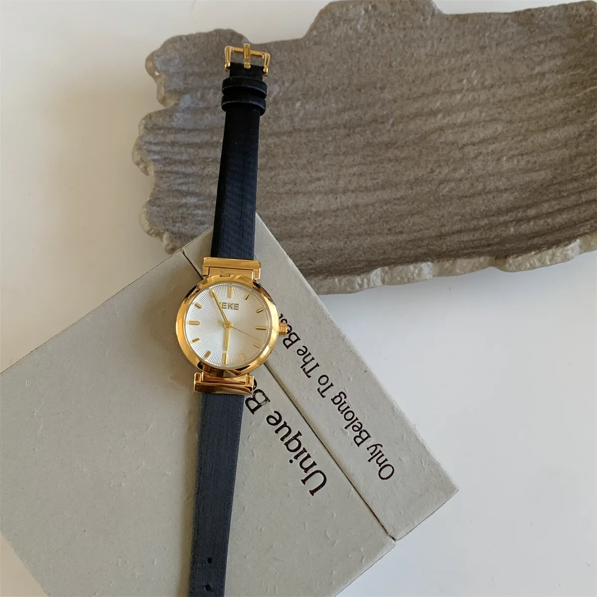 Vintage round women’s leather strap watch in black and gold”