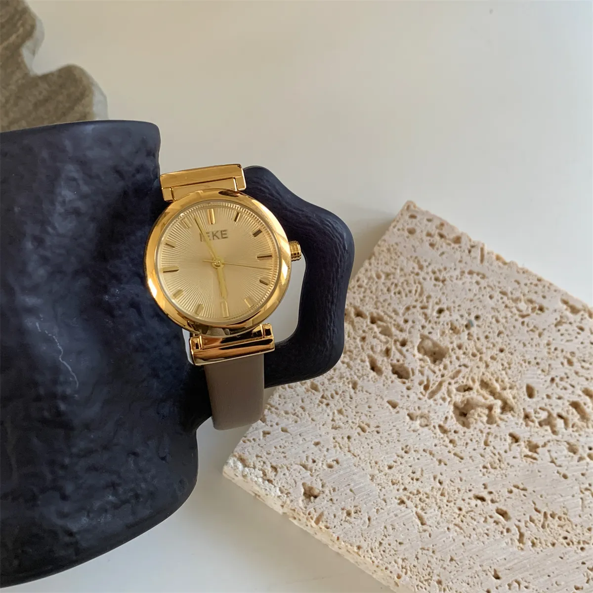 Vintage gold case watch with brown leather strap for women