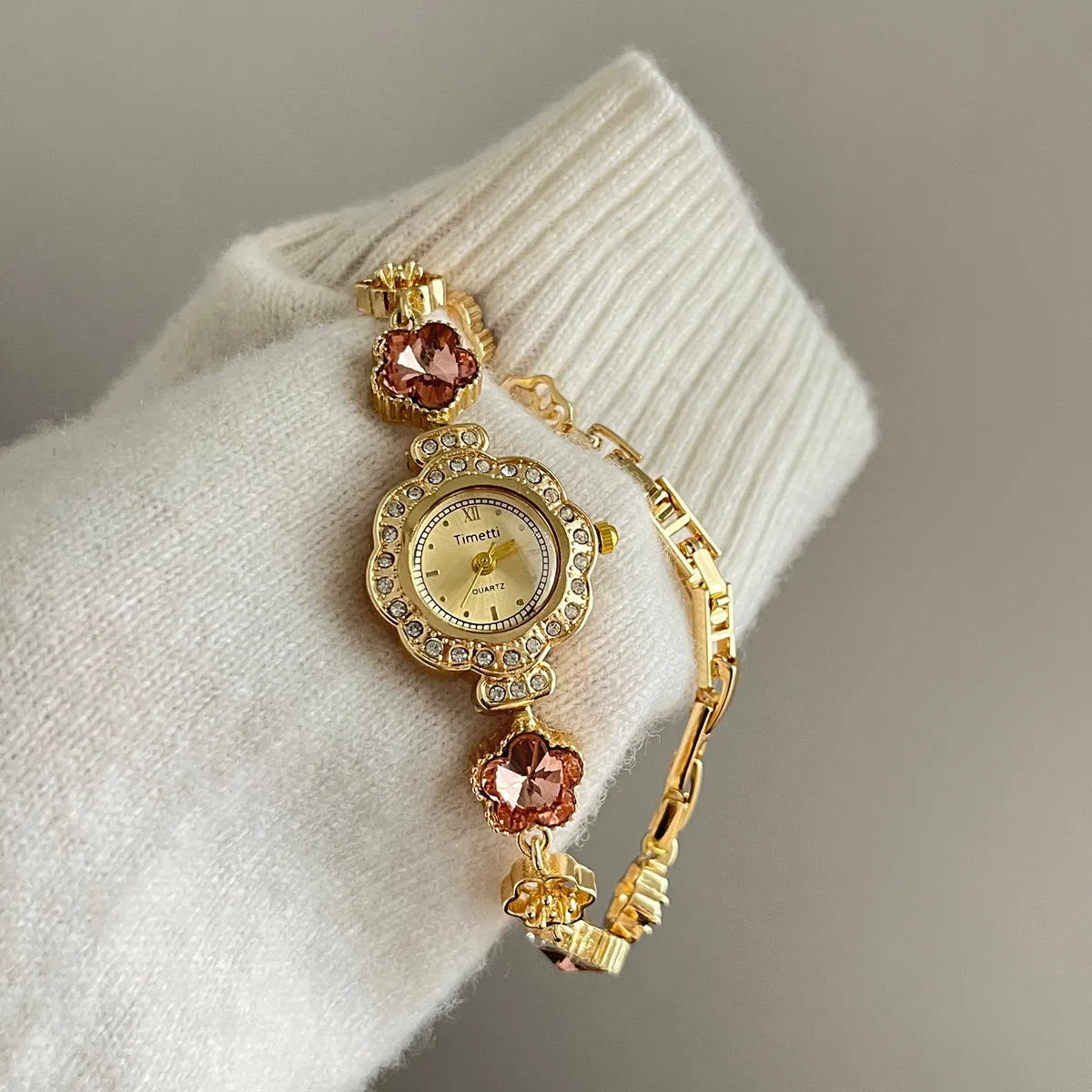 Gold bracelet watch for women with pink floral design