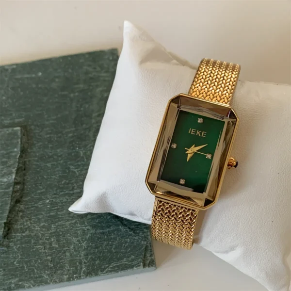 Gold rectangular vintage watch for women with green dia