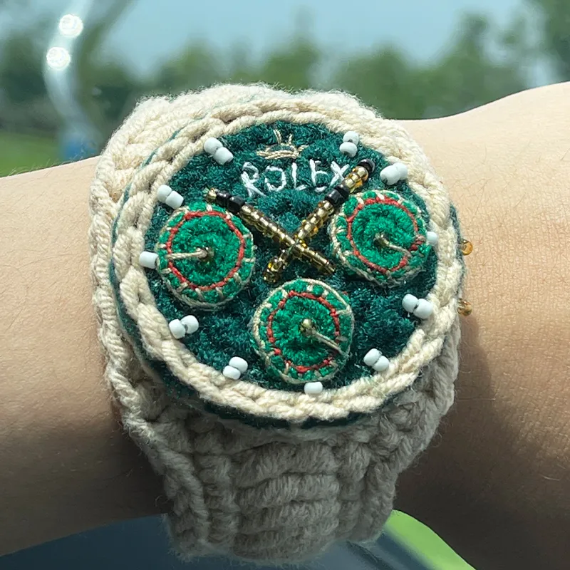 Close-up of handmade knitted yarn watch with embroidered dial