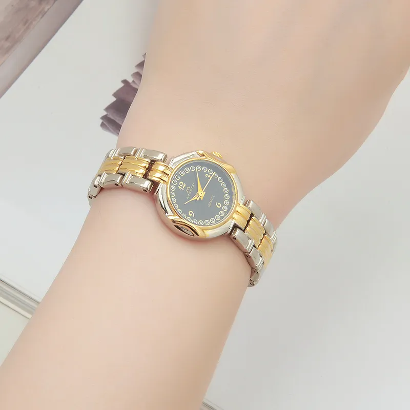 Retro ladies' two-tone gold and silver quartz watch with a black dial and clear Arabic numeral index.