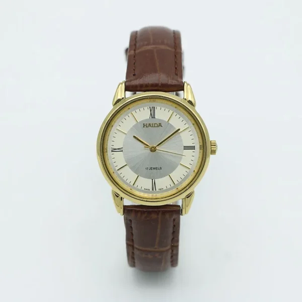 Classic 1960s men’s mechanical leather watch with brown strap and gold case