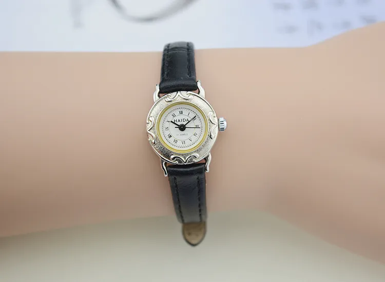 Vintage women’s black leather watch with silver case and Roman numeral dial – WatchTrio