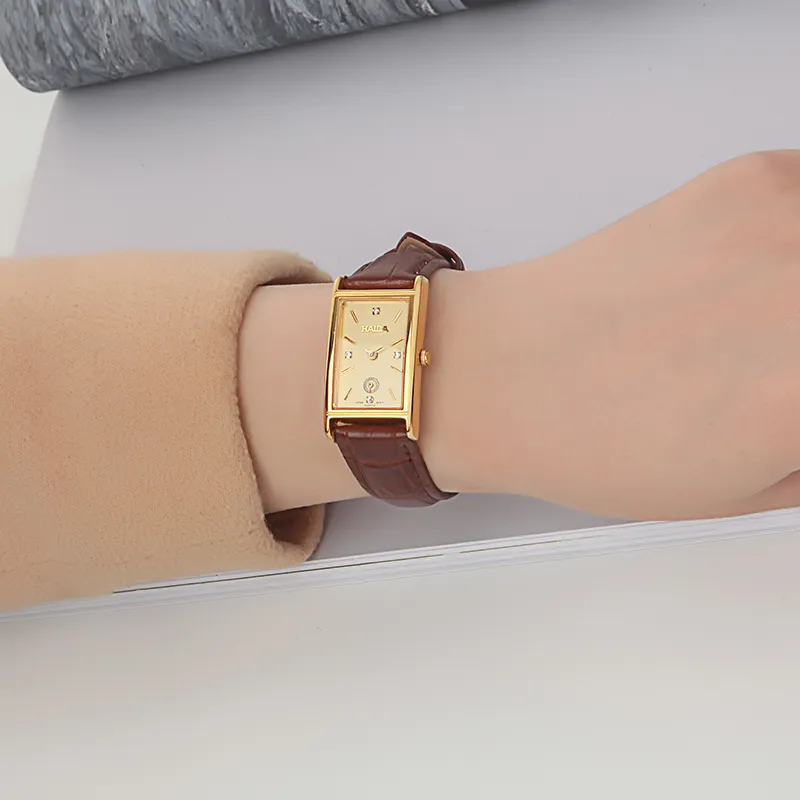 Close-up of vintage leather women’s watch with gold case on wrist – WatchTrio