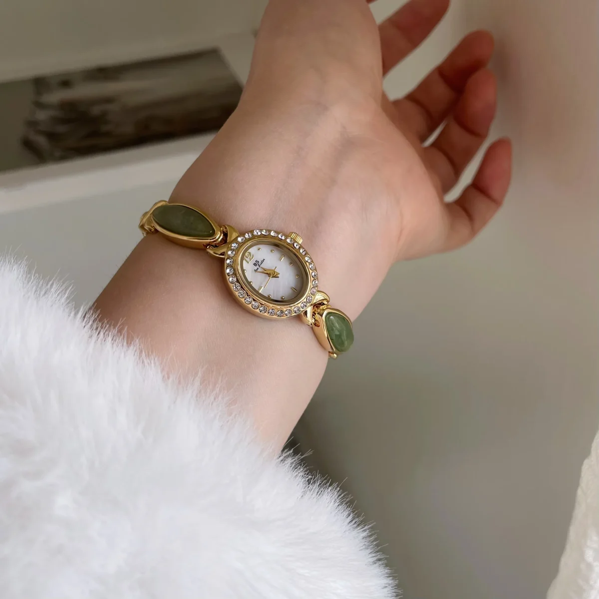 Vintage gemstone oval women’s watch in gold with white dial on wrist – WatchTrio