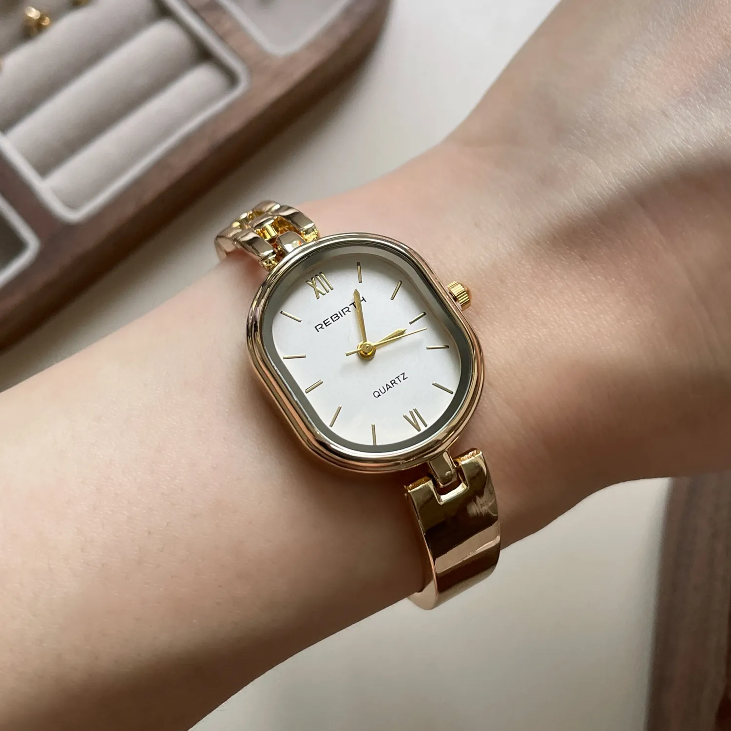 Vintage gold barrel women’s watch on wrist – elegant slim waistline design