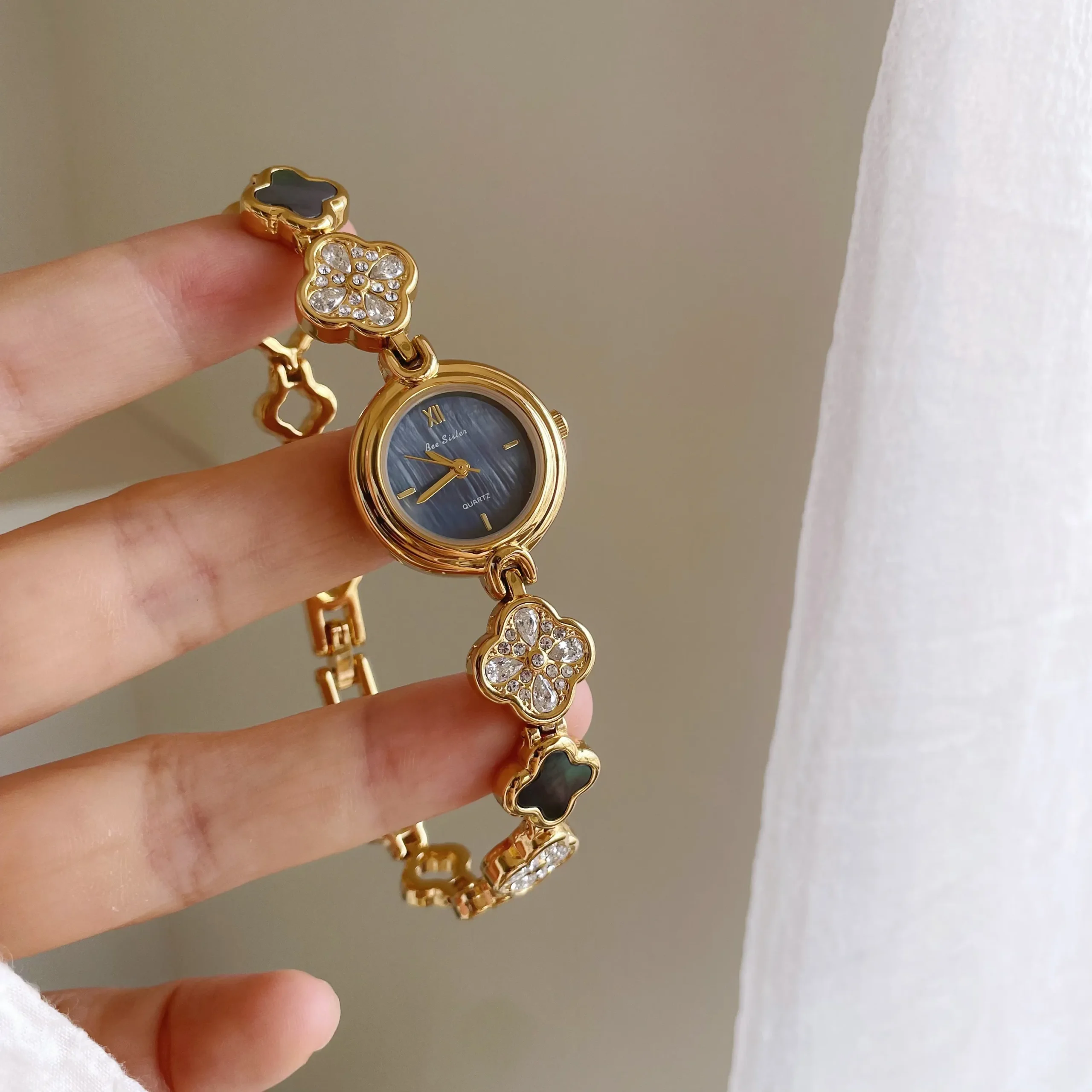 Vintage gold women’s bracelet watch with blue dial and crystal accents – WatchTrio