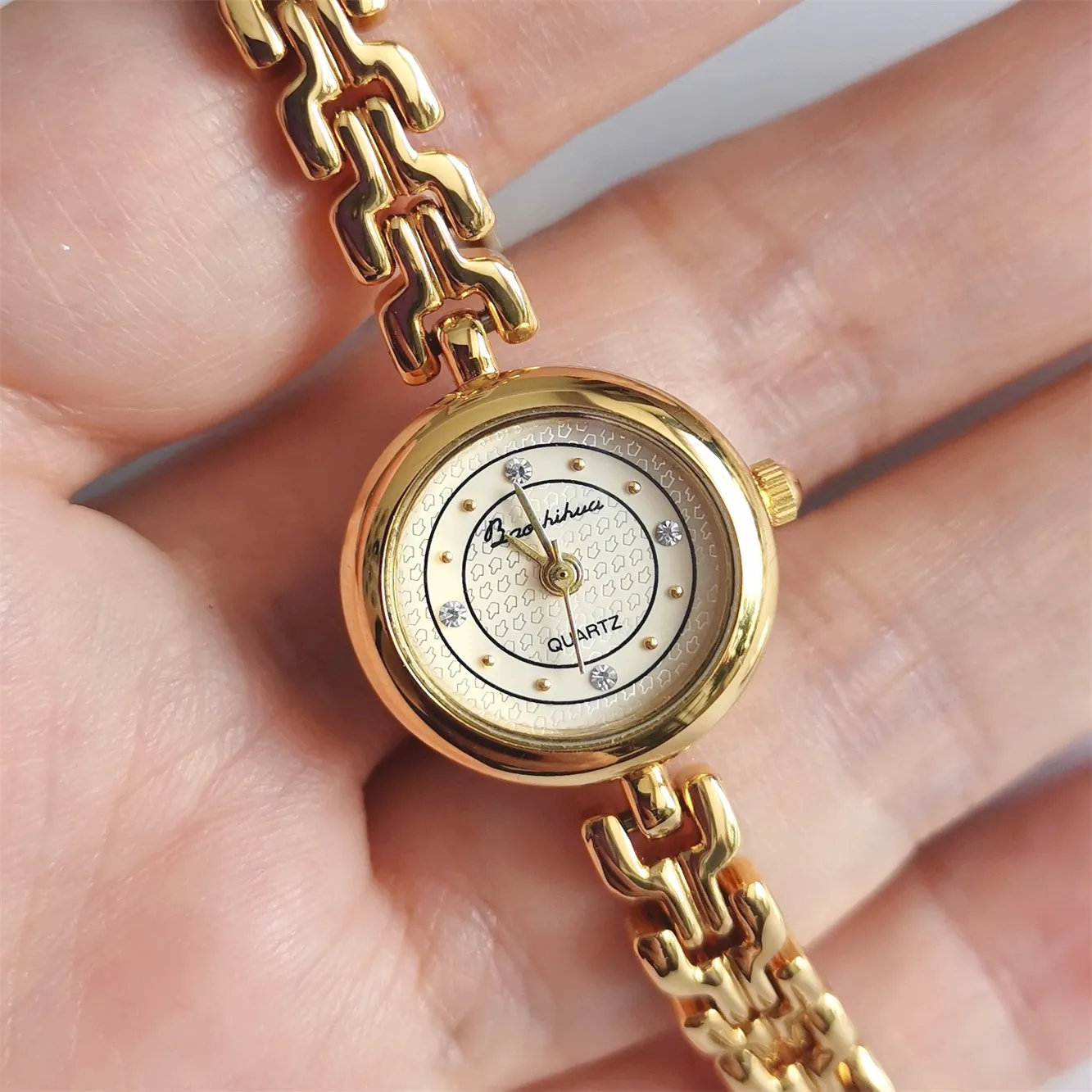 Close-up of petite round dial with crystal markers