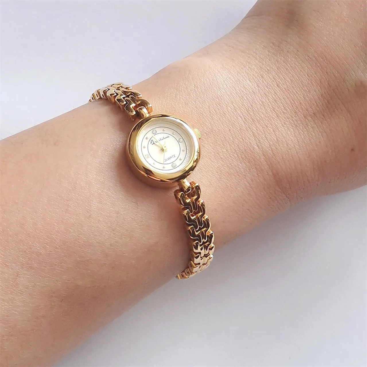 Vintage gold bracelet women’s watch on wrist, angled view