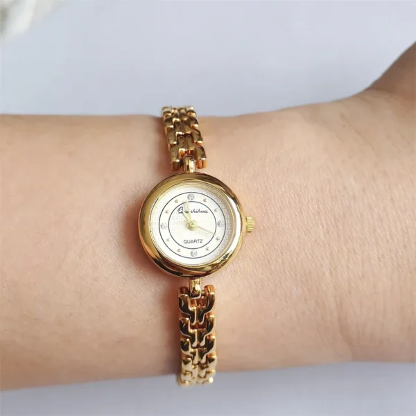 Vintage gold bracelet women’s watch on wrist, angled view