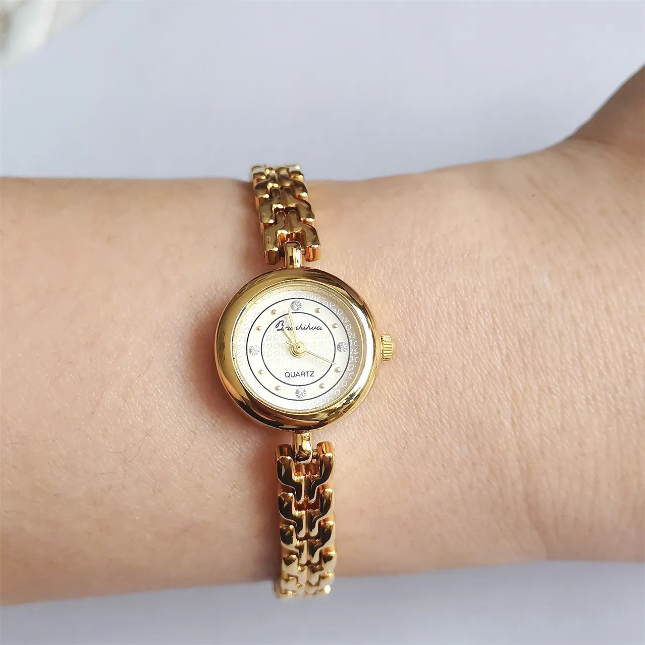 Vintage gold bracelet women’s watch on wrist, angled view