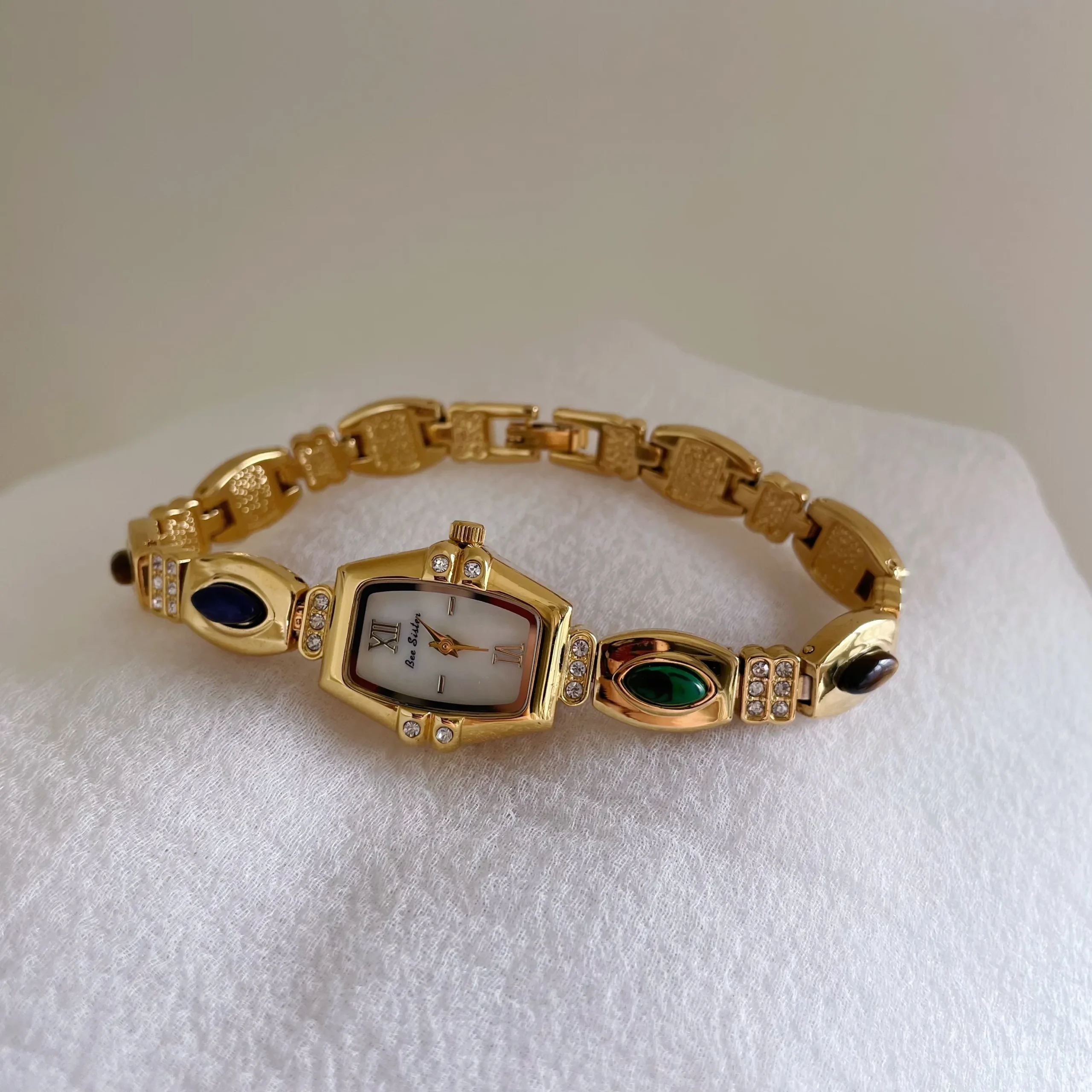 Retro gold women’s bracelet watch with colorful gemstones and barrel dial – WatchTrio