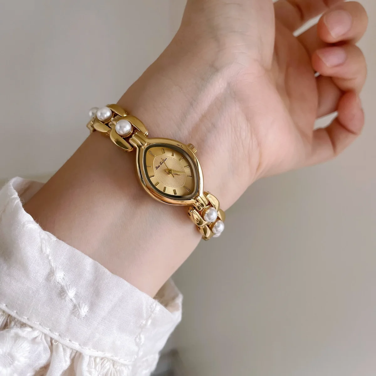 Vintage gold marquise women’s watch with pearl bracelet strap – front view
