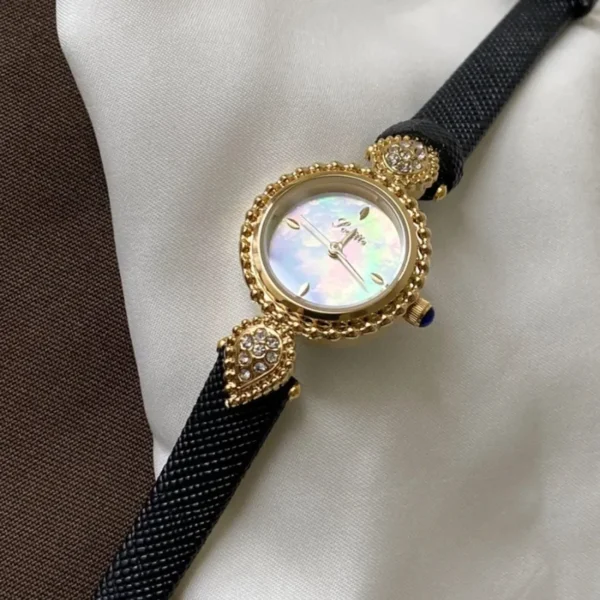 Vintage gold women’s leather strap watch with mother-of-pearl dial and crystal details – WatchTrio