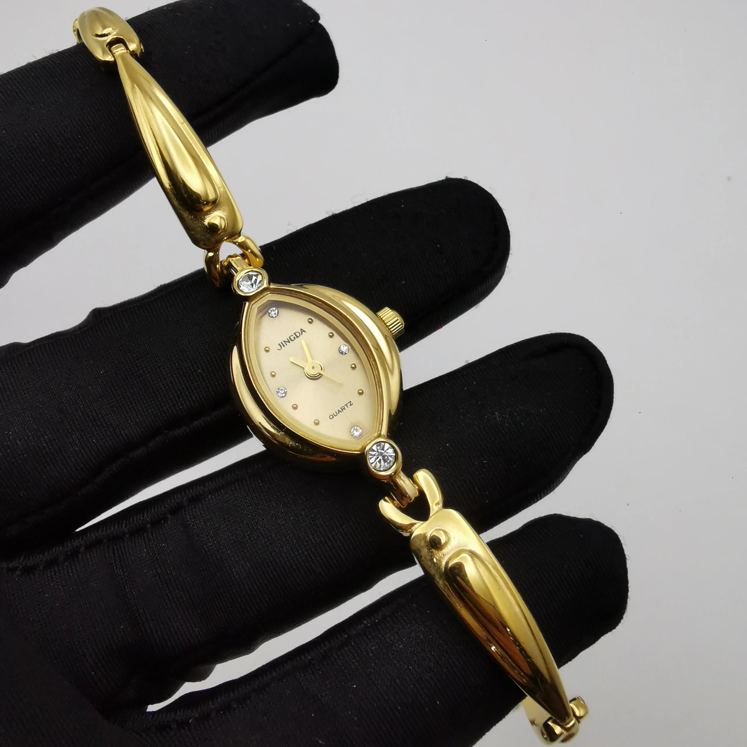 Handheld close-up of vintage gold oval women’s watch – WatchTrio