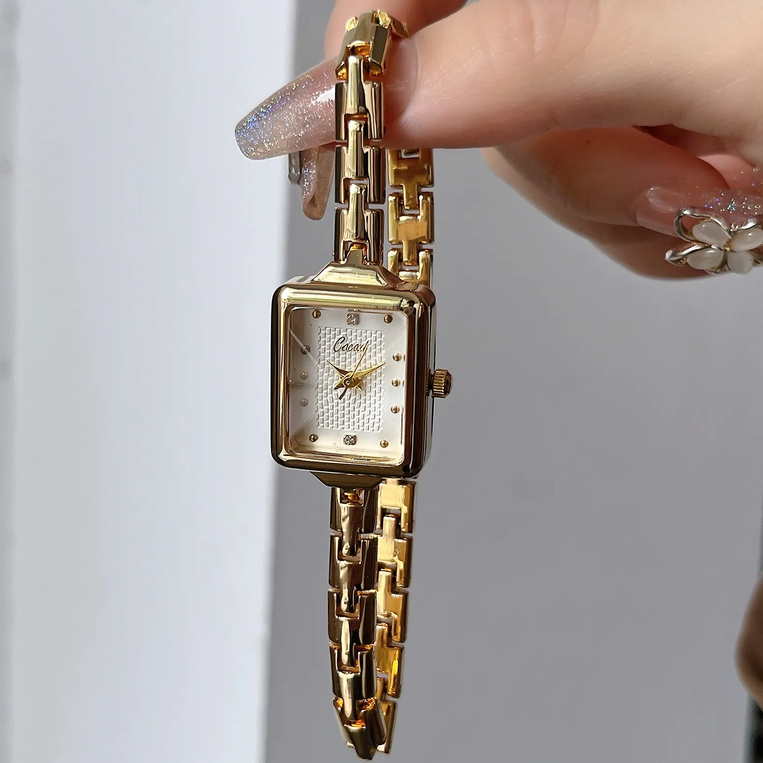 Vintage gold rectangular women’s bracelet watch with white dial close-up