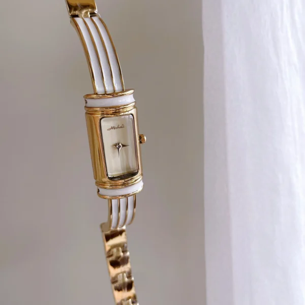 Vintage gold rectangular women’s bracelet watch with white dial and gold case – elegant slim bar retro style.