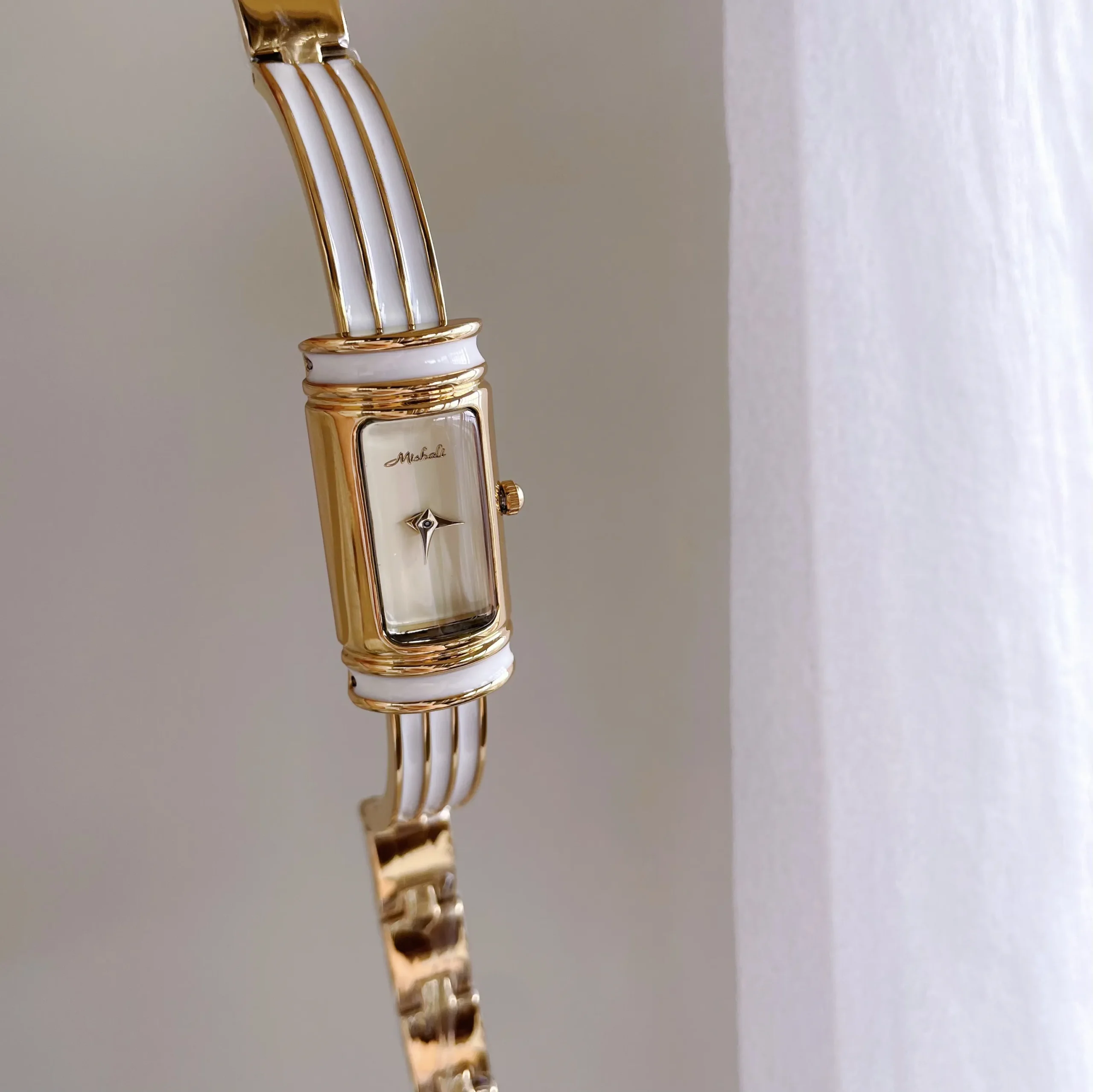 Vintage gold rectangular women’s bracelet watch with white dial and gold case – elegant slim bar retro style.
