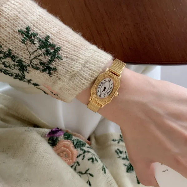 with white dial and gold-tone steel strap