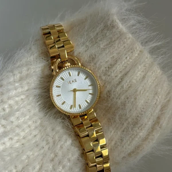 Vintage women's watch with gold strap and white dial