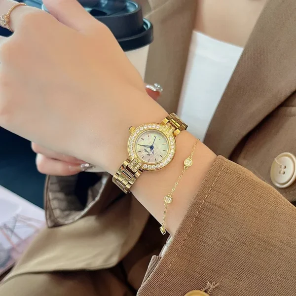 Vintage gold women’s watch with crystal bezel shown on wrist – WatchTrio