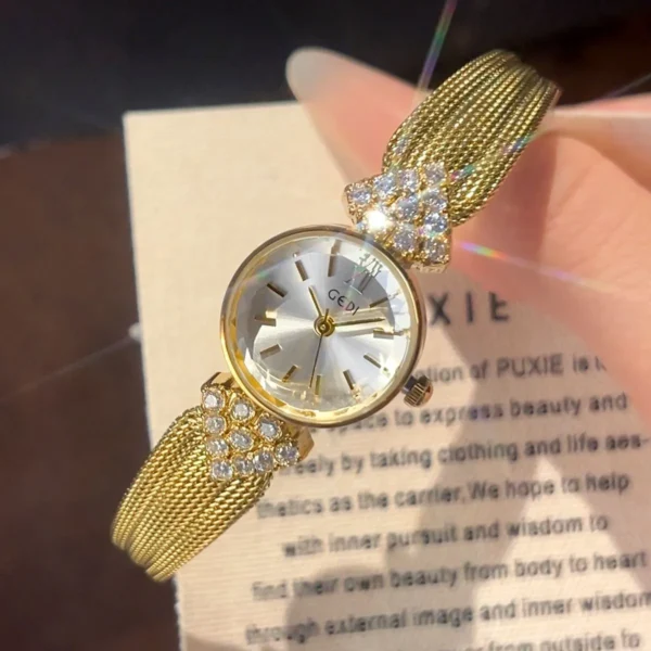 Vintage gold women’s watch with white dial and crystal woven bracelet, handheld close-up – WatchTrio