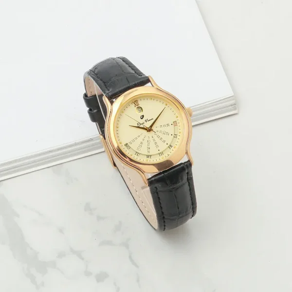 Vintage leather calendar watch with black strap and gold dial on wrist