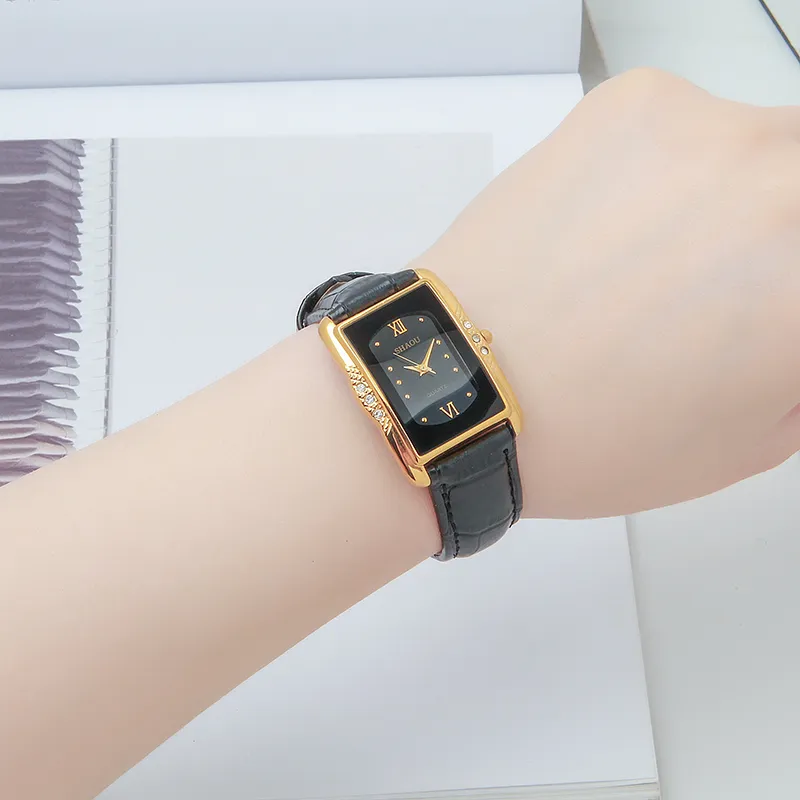 Classic vintage rectangular women’s watch with black leather strap and black dial