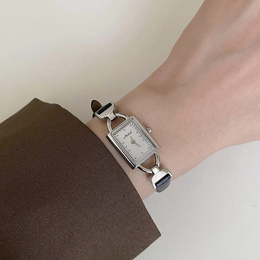 Vintage leather women’s square dial watch with black strap and white face on wrist – WatchTrio