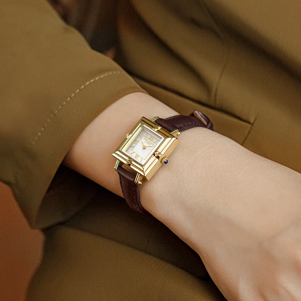 Vintage leather ladies watch with gold case and brown strap on wrist – WatchTrio