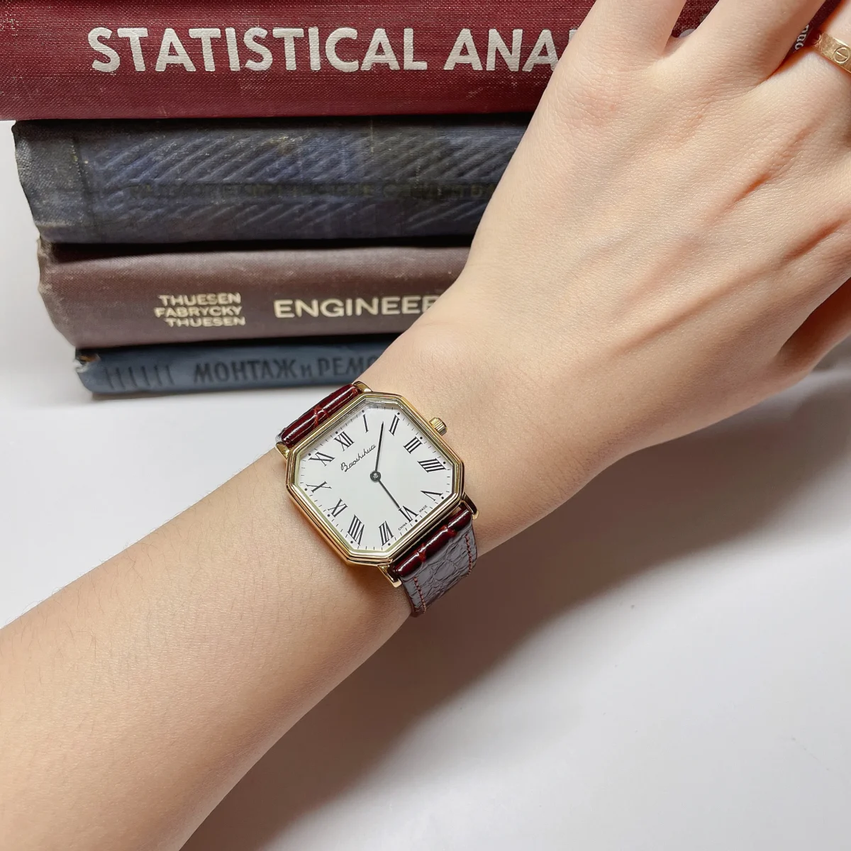 Vintage women’s leather watch with red strap worn on wrist – WatchTrio