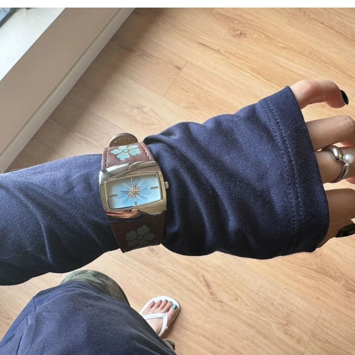 Vintage women’s leather watch with blue floral dial on wrist – WatchTrio