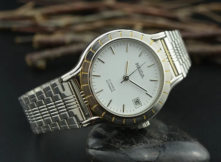 Vintage men’s silver watch with stainless steel strap and white dial