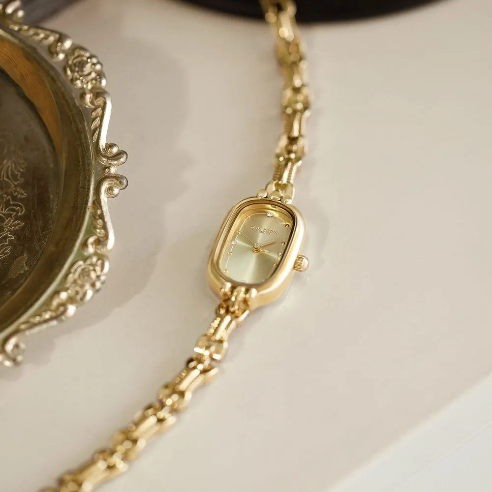 Side view of vintage oval gold quartz women’s watch with steel bracelet – WatchTrio