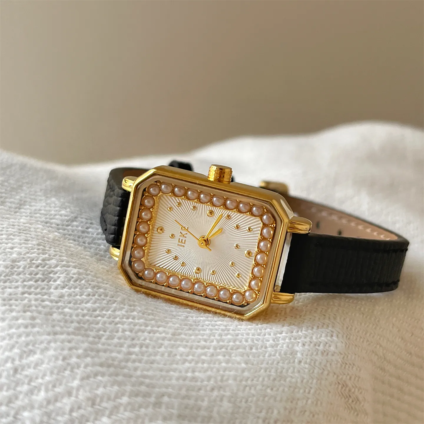 Retro square ladies watch in gold with pearl accents and black leather band