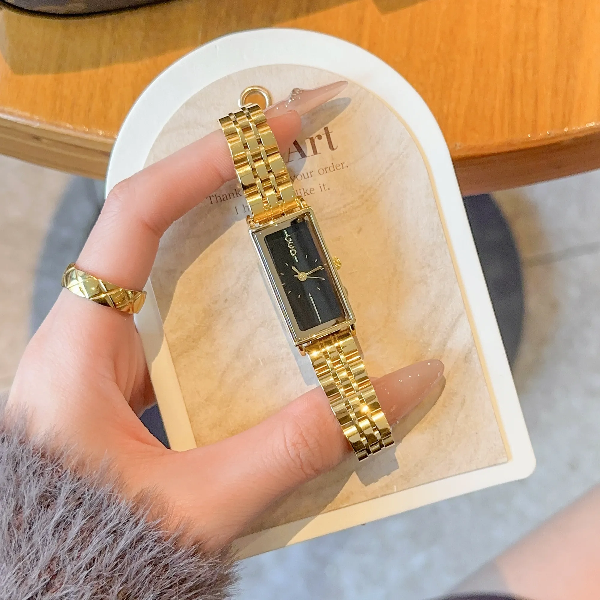 Vintage rectangle women’s gold watch with black dial – WatchTrio