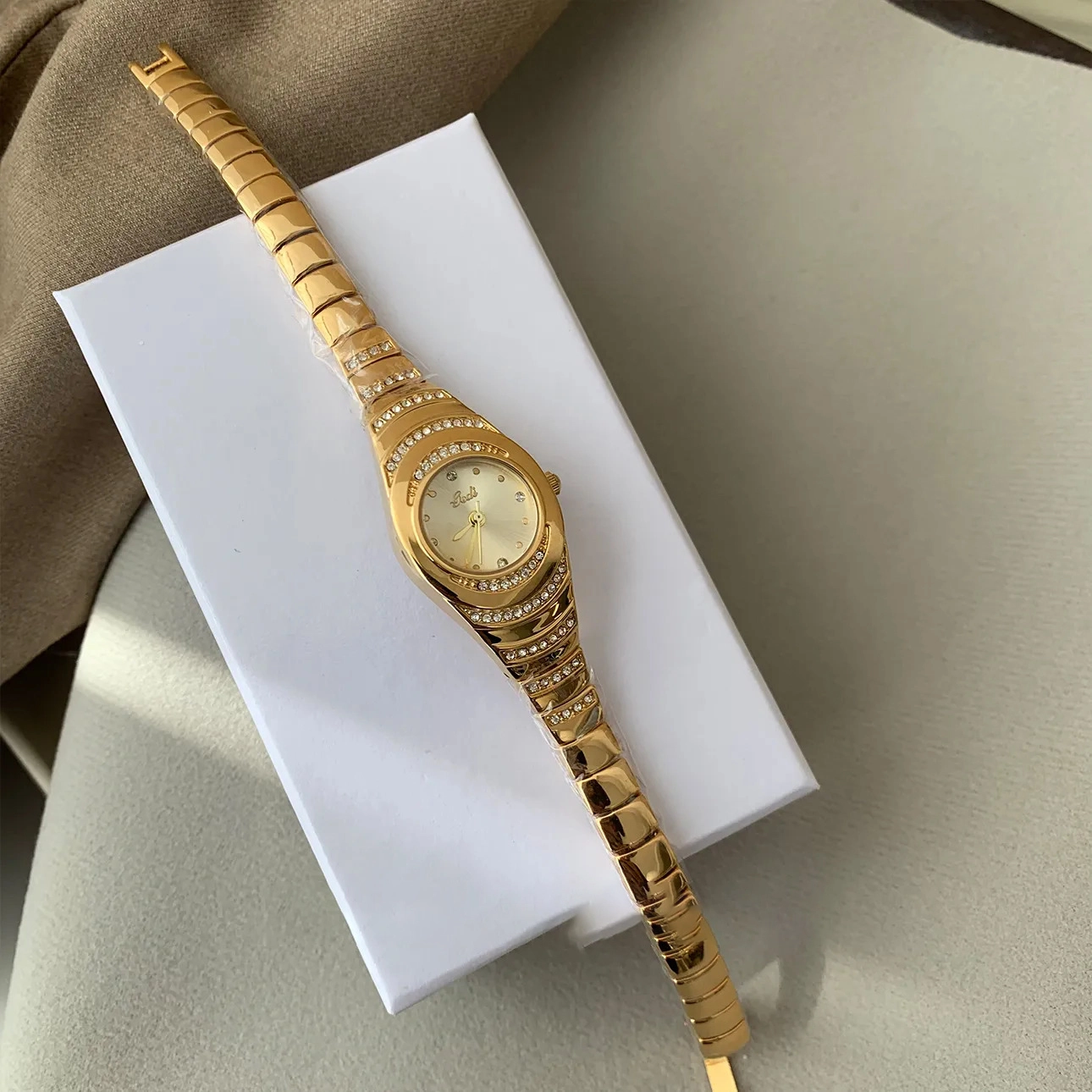 Studio display of serpentine pavé crystal gold women’s bracelet watch – WatchTrio