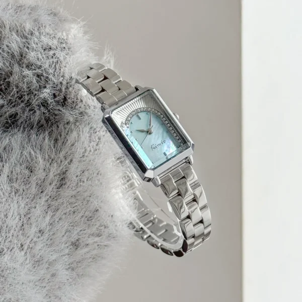 Side view of vintage silver rectangular women’s watch with blue dial – WatchTrio