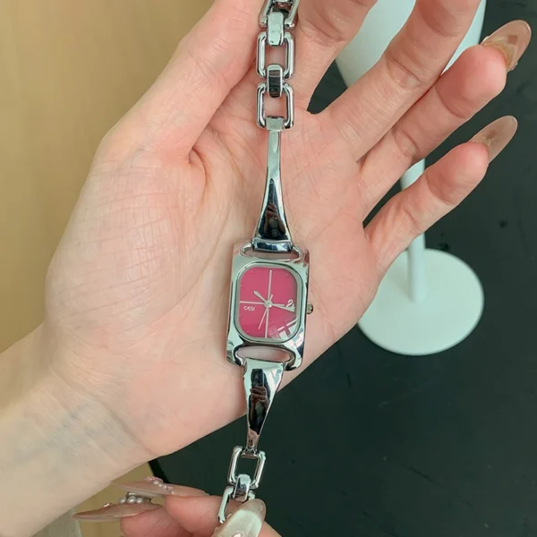 Close-up of vintage silver watch showing its rectangular face.
