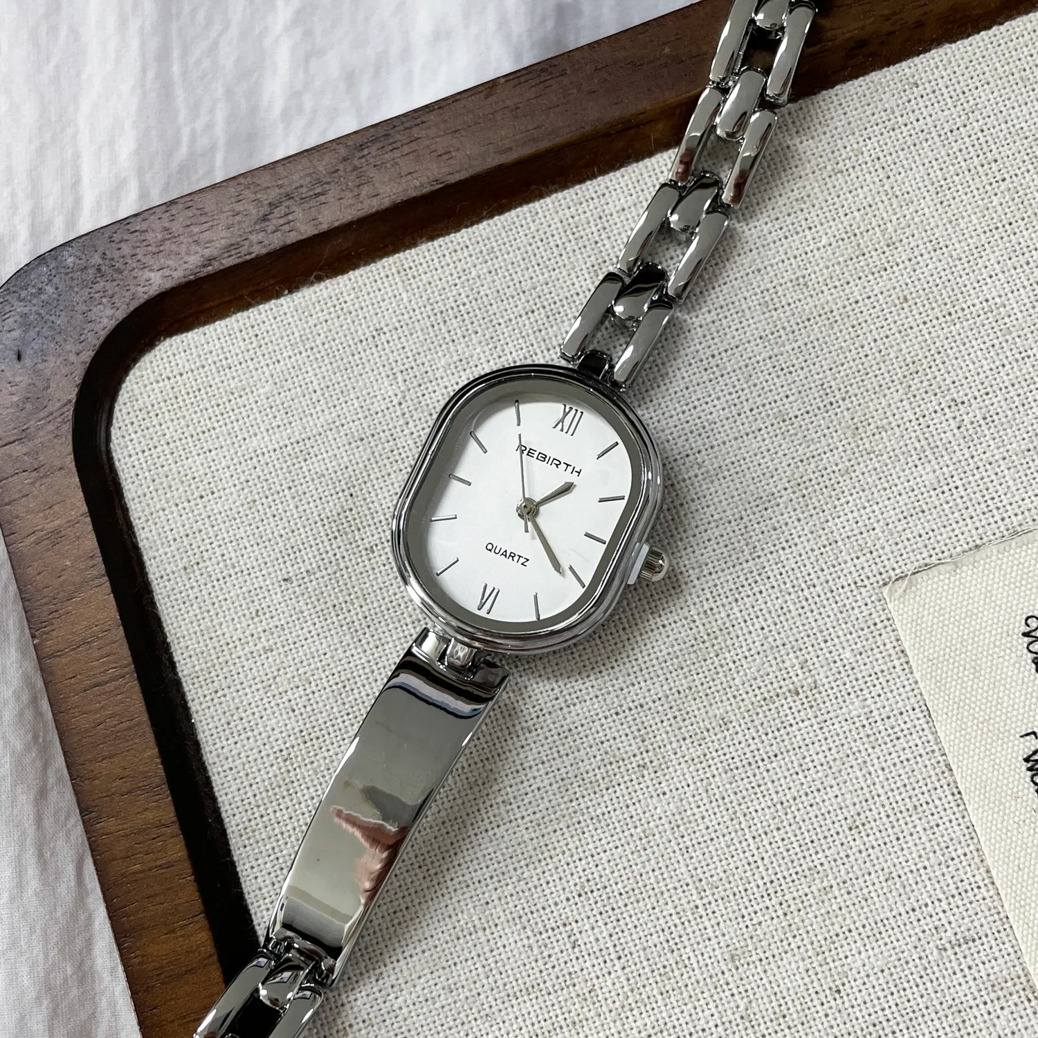 Vintage silver ladies watch with barrel waist design and stainless steel strap, elegant retro style