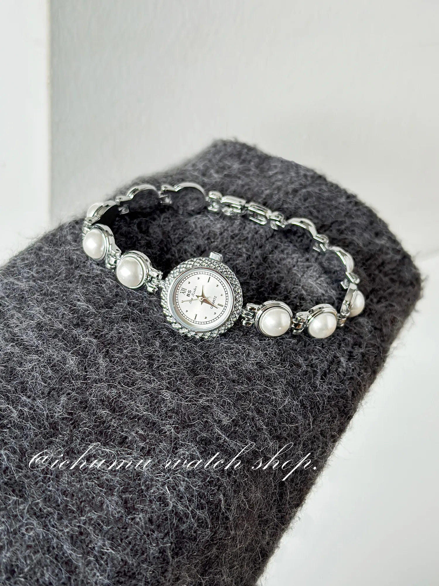 Flatlay of vintage silver women’s watch with pearl bracelet design – WatchTrio