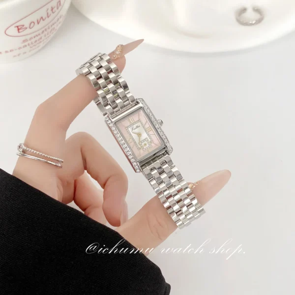 Vintage silver women’s watch with rectangular pink dial shown on hand – WatchTrio