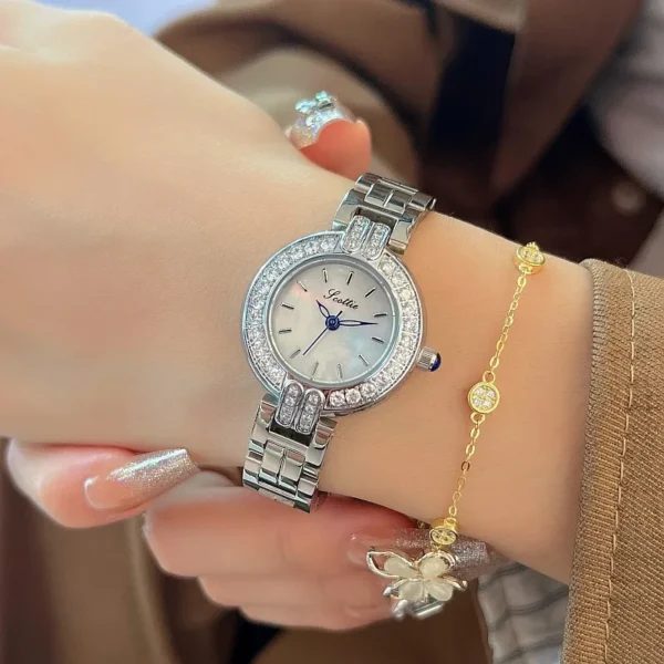 Vintage silver women’s watch with crystal bezel shown on wrist – WatchTrio