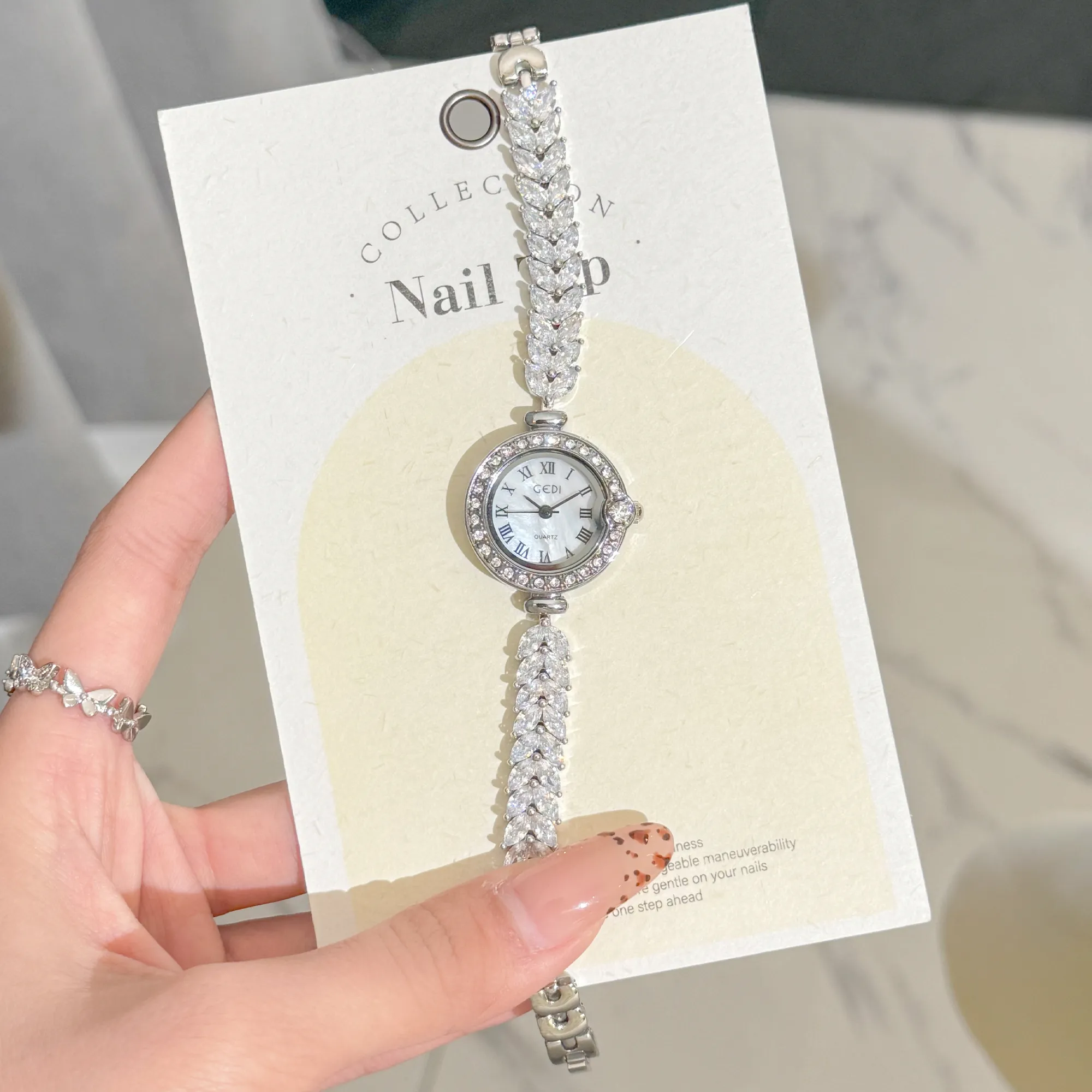 Elegant vintage women’s silver watch on flatlay – wheat bracelet | WatchTrio