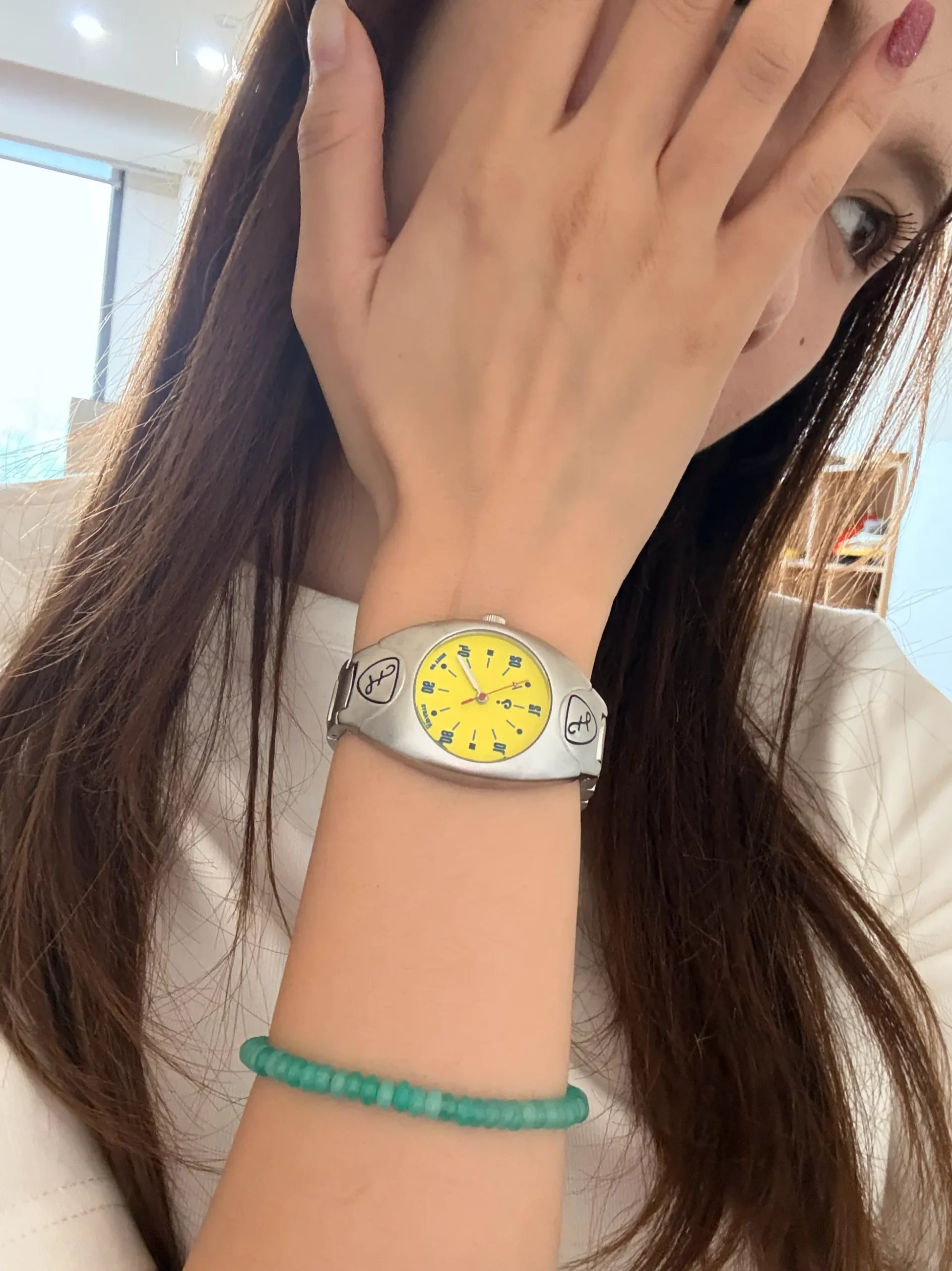 Vintage silver women’s wristwatch with yellow dial, retro quartz design, worn on wrist – WatchTrio