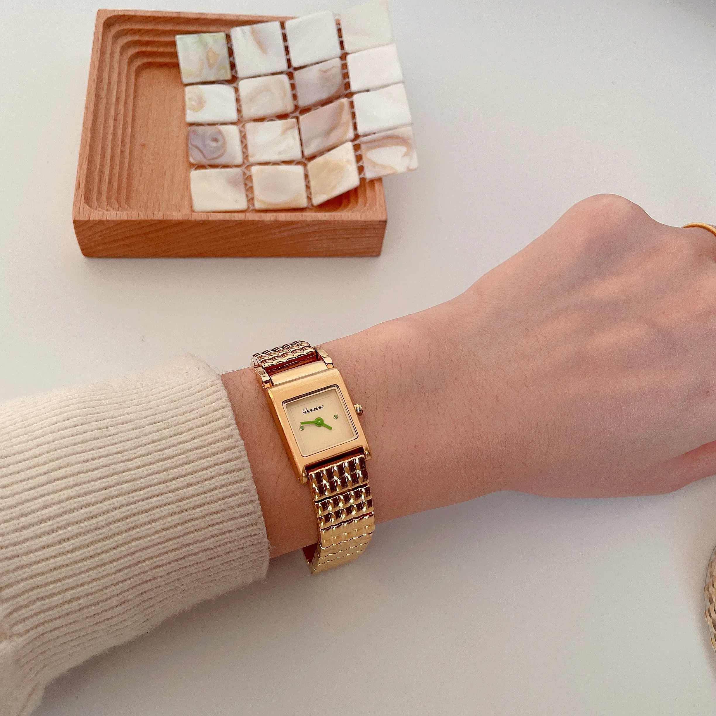 Retro gold square women’s watch on wrist