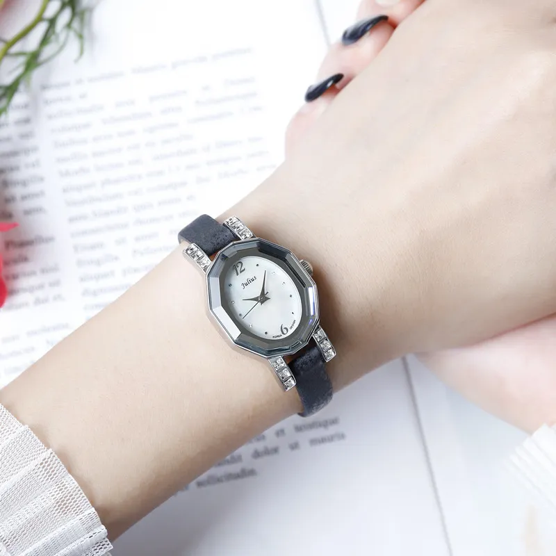 Vintage women’s watch with white strap, shell dial, and crystal embellishments